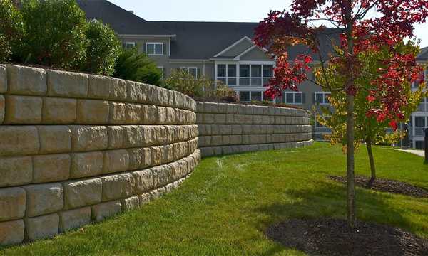Red brick retaining wall along an apartment complex walkway
